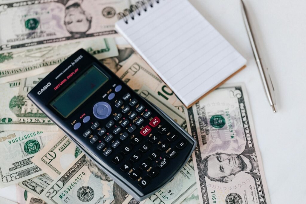 A grocery receipt and calculator next to fruit on a table