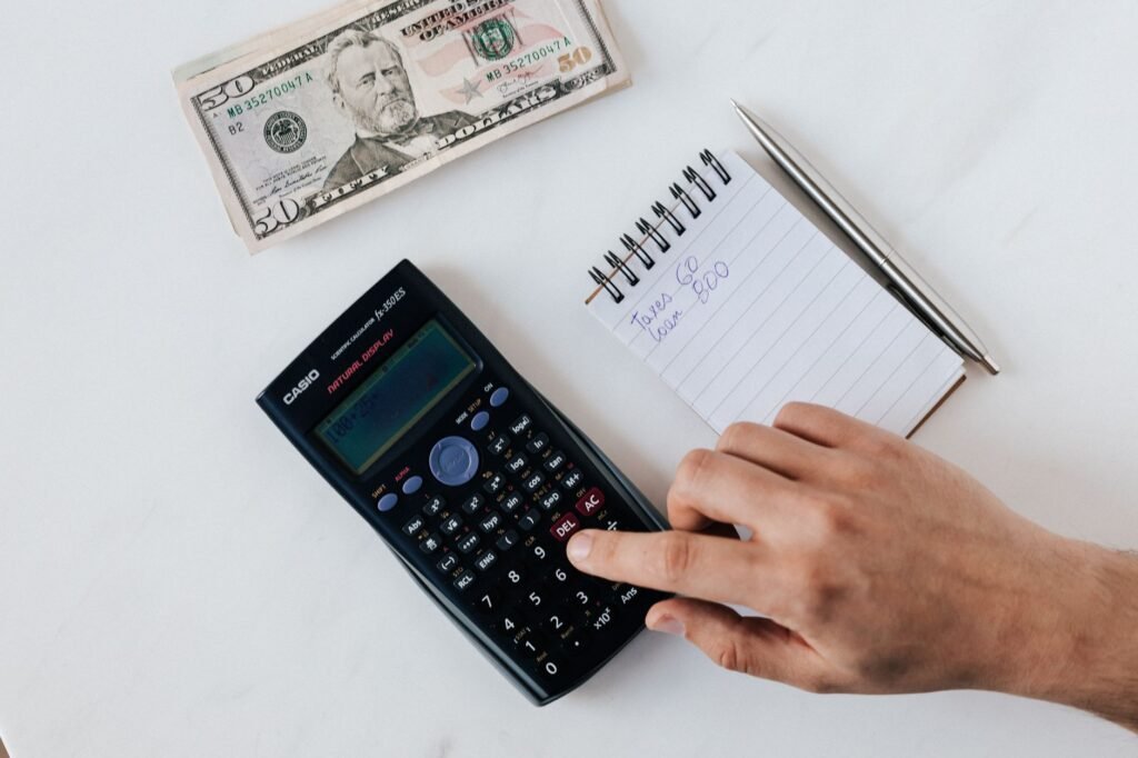 Calculator and grocery receipt next to simple dinner ingredients on a countertop